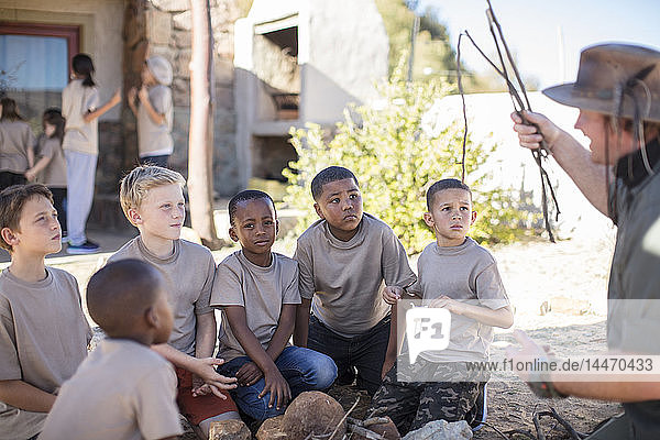 Children learning how to make a fire