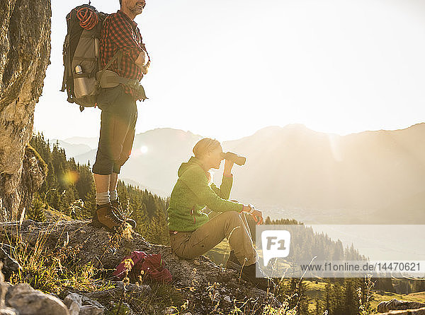 Couple taking a break in the mountains  looking at view