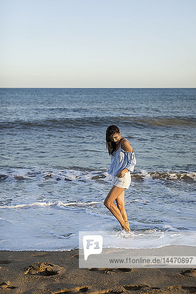 Portrait of a beautiful woman on the beach  standing in water