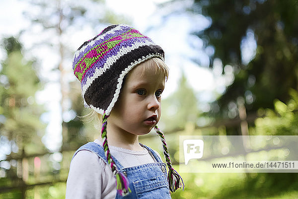 Portrait of little girl wearing knitted hat