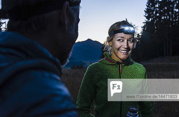 Couple hiking at night  wearing head lamps