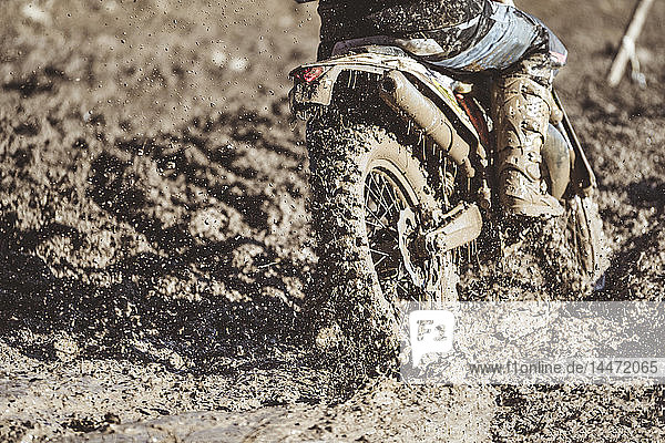 Close-up motocross wheel with water and mud
