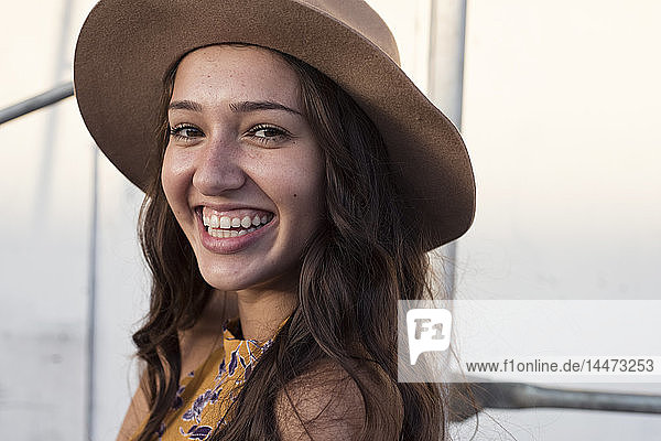 Portrait of happy young woman wearing a hat