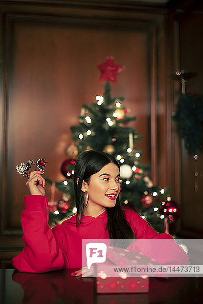 Portrait of smiling teenage girl with Christmas present