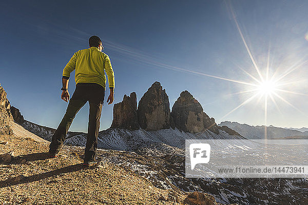 Italy  Tre Cime di Lavaredo  man hiking and standing in front of the majestic three peaks
