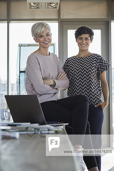 Portrait of two smiling businesswomen in office