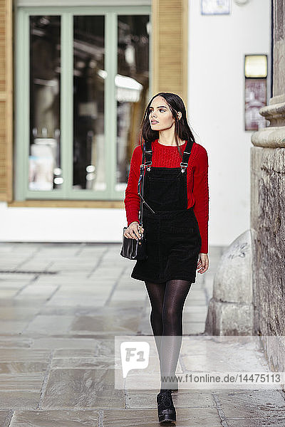 Portrait of fashionable young woman at shopping street