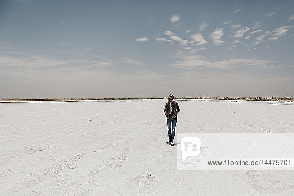 Namibia  Walvis Bay  woman walking on a salt plain
