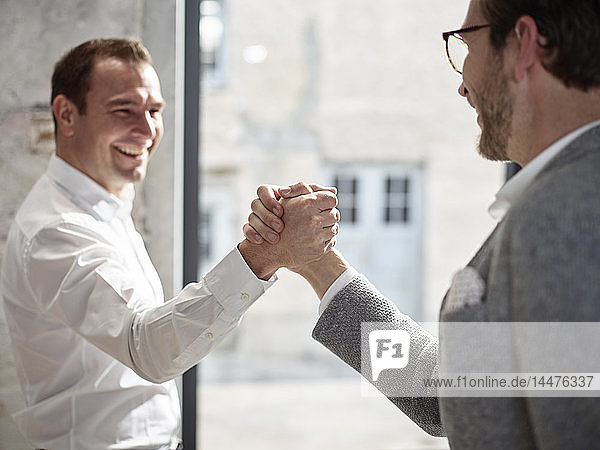 Two happy businessmen shaking hands