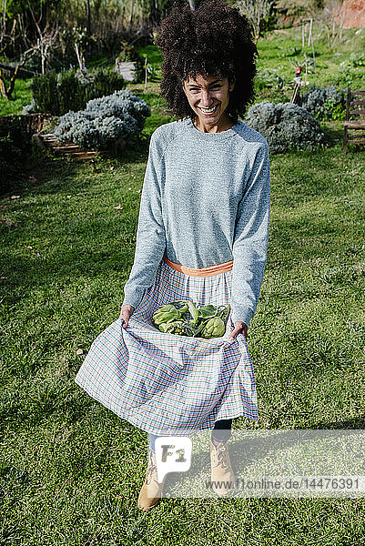 Woman carrying freshly harvested in her apron