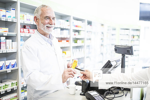 Customer paying cashless in a pharmacy