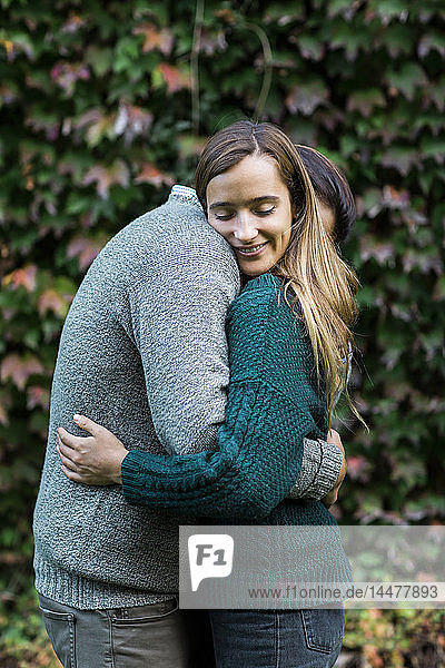 Happy affectionate couple hugging outdoors