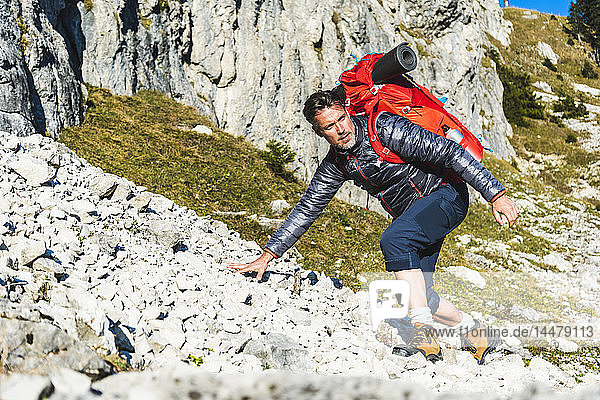 Man mountain hiking in rocky terrain