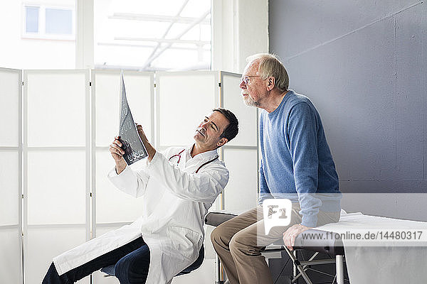 Doctor discussing MRT image with patient in medical practice