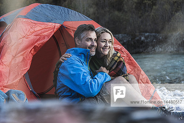 Mature couple camping at riverside