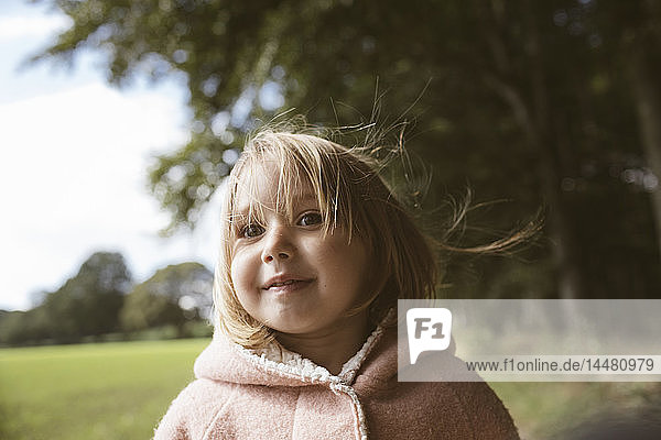 Portrait of blond little girl with blowing hair