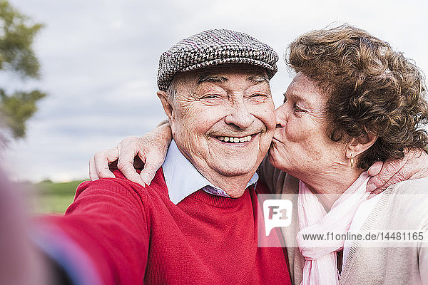 Selfie of happy senior couple outdoors