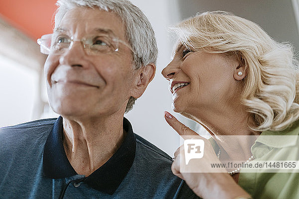 Senior woman talking to husband with hearing aid