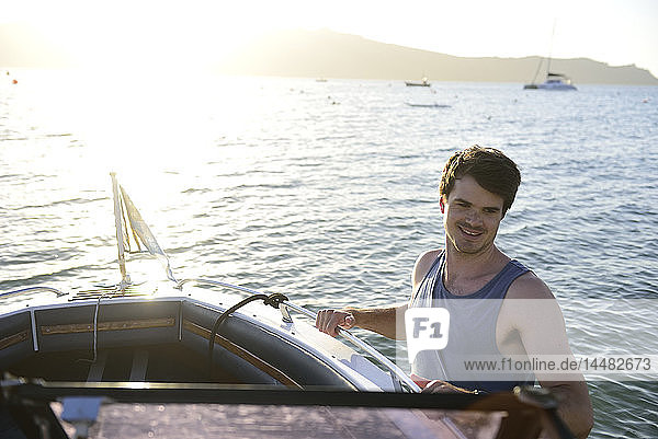 Smiling young man on a boat in the sea
