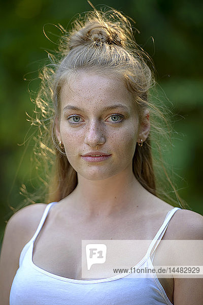 Portrait of freckled teenage girl in summer