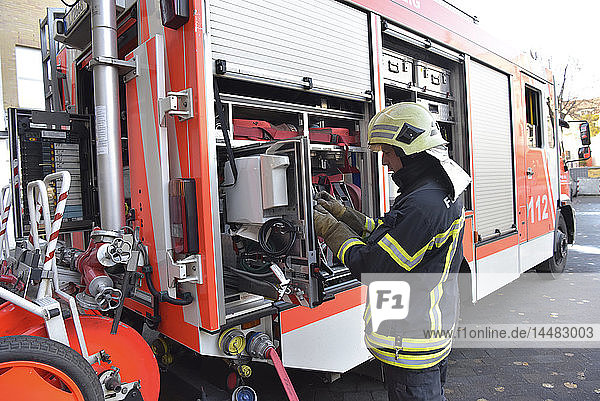 Firefighter standing at fire engine