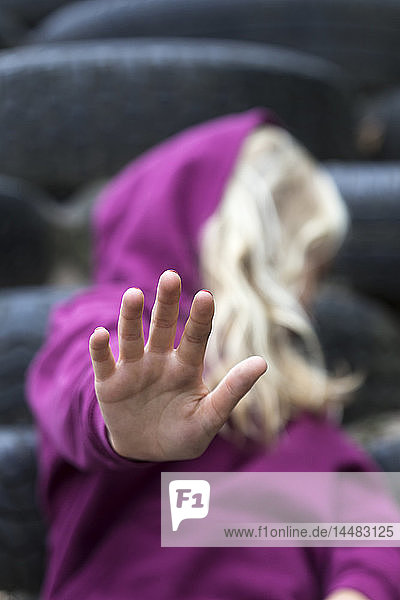 Girl raising her hand  close-up