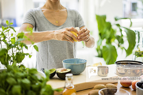Woman preparing healthy food in her kitchen