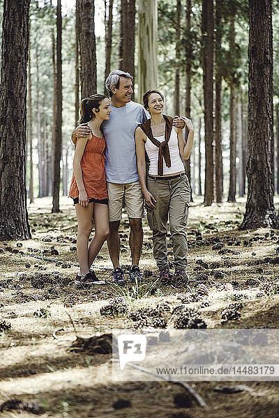 Family standing in forest