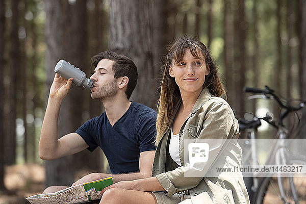Young couple resting in pine forest