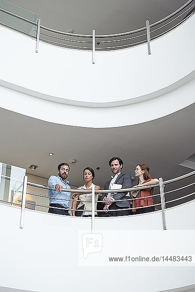 Businessman pointing while talking with his colleagues