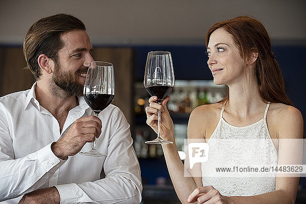 Mid adult couple holding wine glass