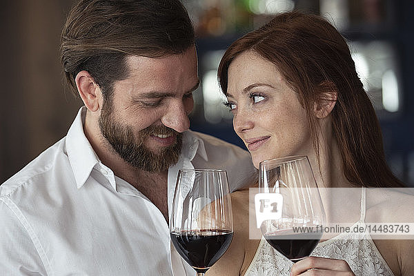 Smiling couple holding wine glass