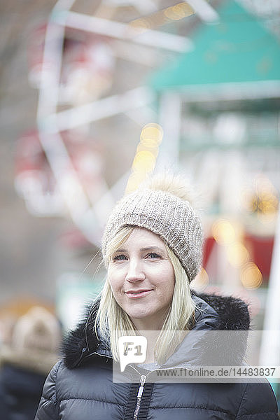 Portrait confident woman in warm clothing at carnival