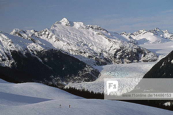Mendenhall Glacier Southeast Alaska Winter Cross Country Skiers Snow Mountains Forest Sky