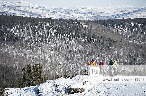 Friends take in the view during a day of downhill skiing at Mt. Aurora Skiland near Cleary Summit north of Fairbanks  Alaska