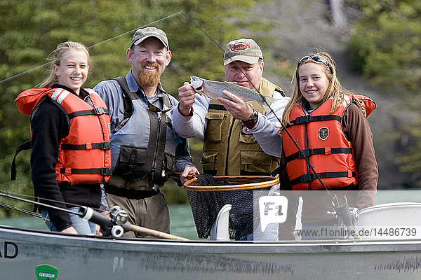Family & Guide showing off Rainbow Trout caught from drift boat Kenai River Kenai Peninsula Alaska