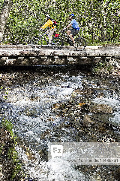 Mother & Son Biking on Bridge Over Creek Alaska SC Chugach SP near Eklutna Lake