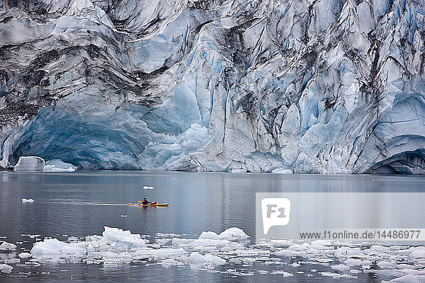 Man kayaking in Shoup Bay with Shoup Glacier in the background  Shoup Bay State Marine Park  Prince William Sound  Southcentral Alaska