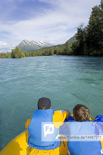 Young boys in bow of river raft looking downriver Kenai River Kenai Peninsula Alaska Summer