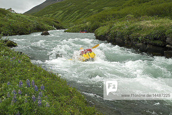 Woman pack rafts down the Aniakchak River in Aniakchak National Monument and Preserve in Southwest Alaska