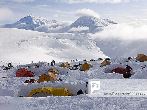 Climbers create protective snow walls around their tents to provide shelter from high winds at the 11 000-foot camp on Denali´s West Buttress route in Denali National Park. Spring in Interior Alaska.
