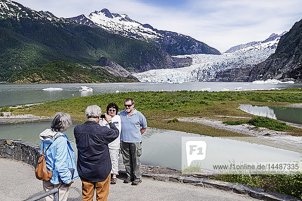 Tourists photographing Mendenhall Glacier and tourists in Tongass National Forest  Southeast Alaska
