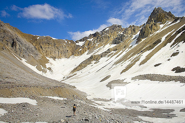 Woman hiking in the Jumbo mine glacial bowl above Kennecott in Wrangell-St. Elias National Park  Alaska