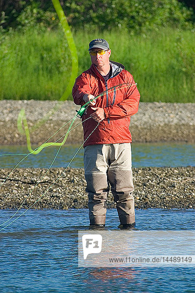 Fly-fisherman casts a two handed spey rod for Chinook salmon on Kanektok River Chugach State Park Alaska