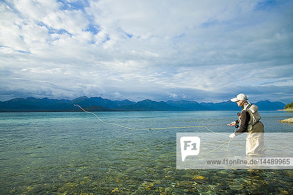 Person flyfishing in Lake Clark of Lake Clark National Park near the mouth of Tanalian River in Southcentral Alaska during Summer