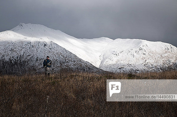 Ein Hirschjäger sucht auf einem Bergrücken in der Nähe des Frazer Lake  Kodiak Island  Südwest-Alaska  nach Wild