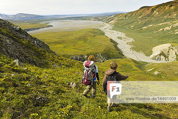Pair of hikers on a ridge in the Alaska Range above Thorofare River  Denali National Park  Interior Alaska  Summer/n