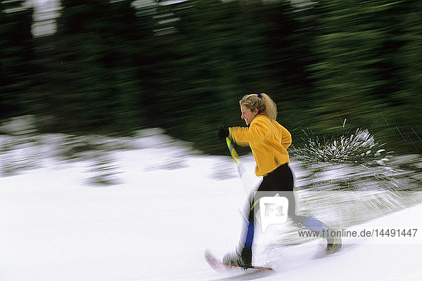 Woman Runs in Snowshoes Southcentral AK Winter