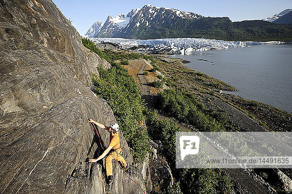 Man rock climbing with Spencer Glacier in the background  Chugach National Forest  Kenai Peninsula  Southcentral Alaska  Summer