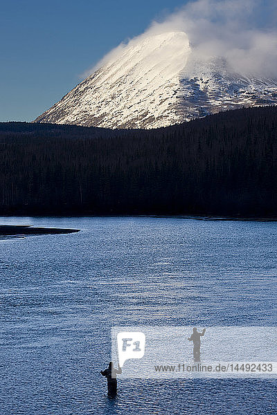 Anglers fishing on the Kenai River at the mouth of Kenai Lake during Winter  Kenai Peninsula  Southcentral Alaska